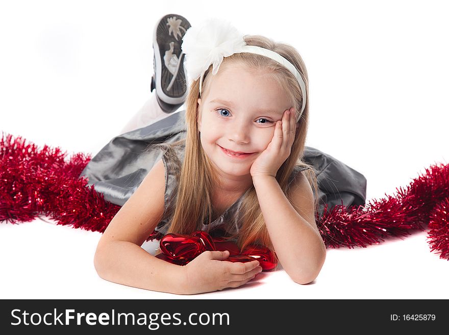 Smiling little girl with new year toys isolated