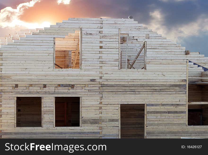 Process of building of a new cottage against the sky and sunset. Process of building of a new cottage against the sky and sunset