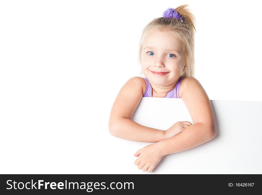 Surprised little girl looking over empty board isolated