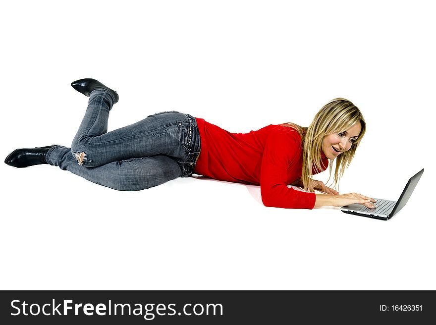 Happy working woman lying on the floor with her laptop