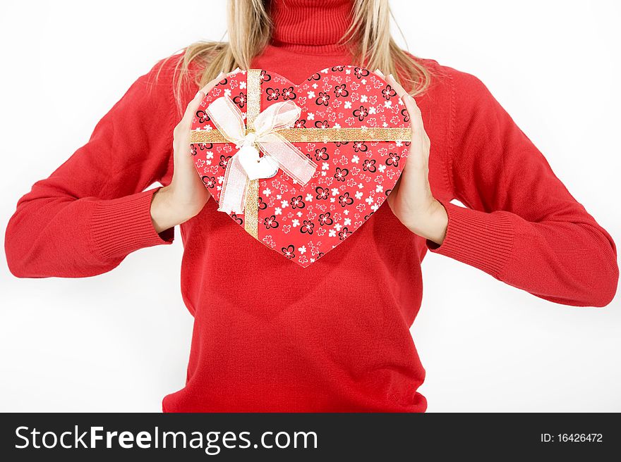 Woman holding a heart shaped red box. Woman holding a heart shaped red box