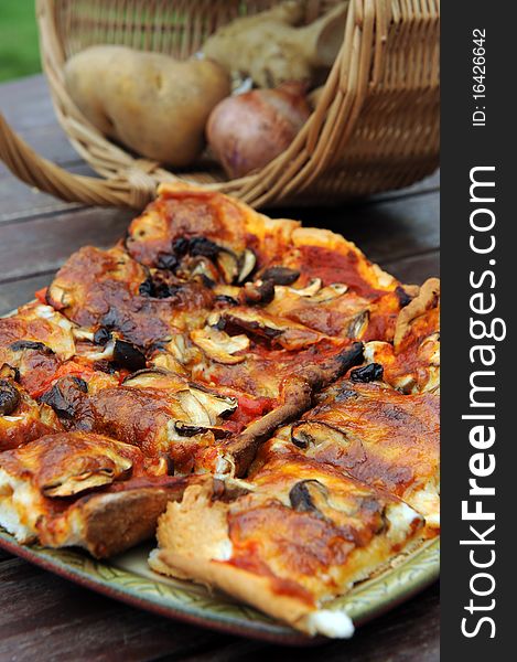 A slice of hot, fresh pizza being served,on wood table.