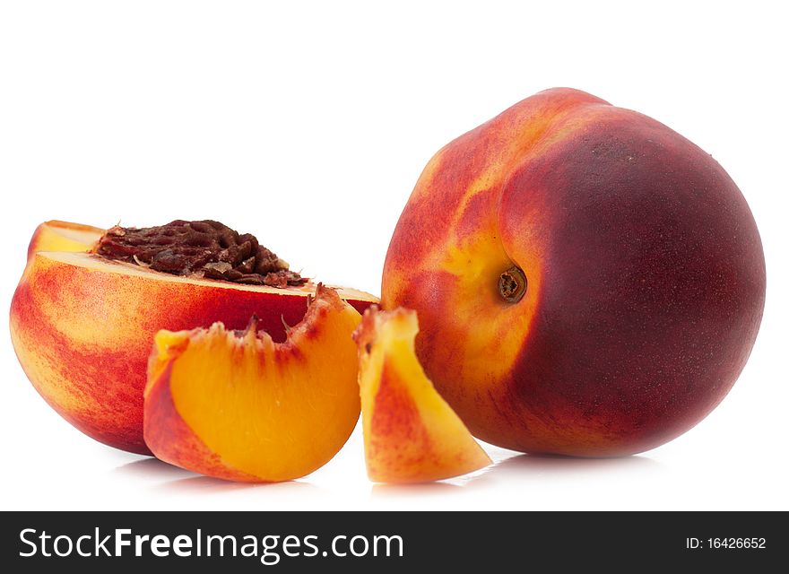 Tasty juicy peaches and slices of peaches on a white background