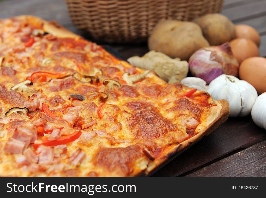 Close Up Of A slice of hot, fresh pizza being served,on wood table. Close Up Of A slice of hot, fresh pizza being served,on wood table.