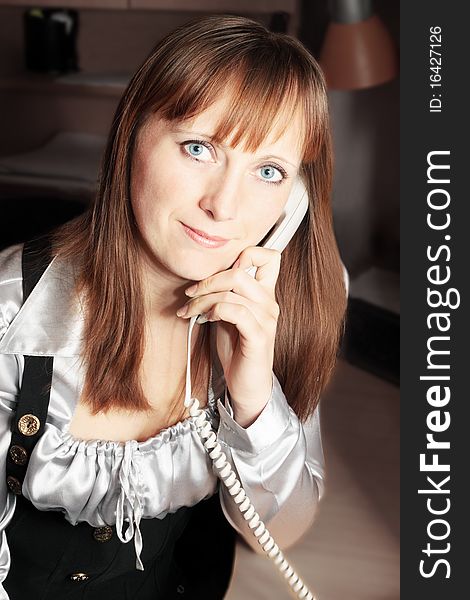 Young beautiful business lady speaks on the telephone