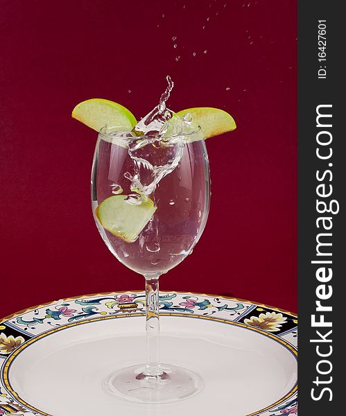 Apple Slice Splashing in Water On Plate