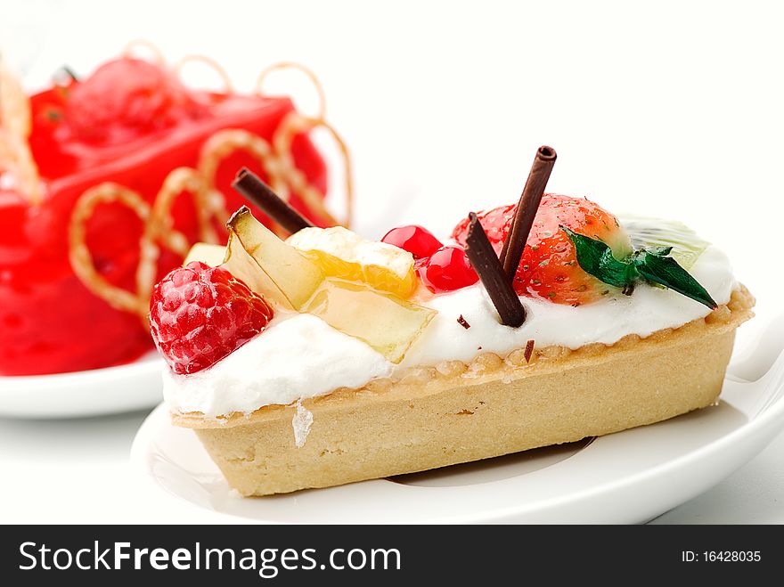 Cake with strawberry topping over white