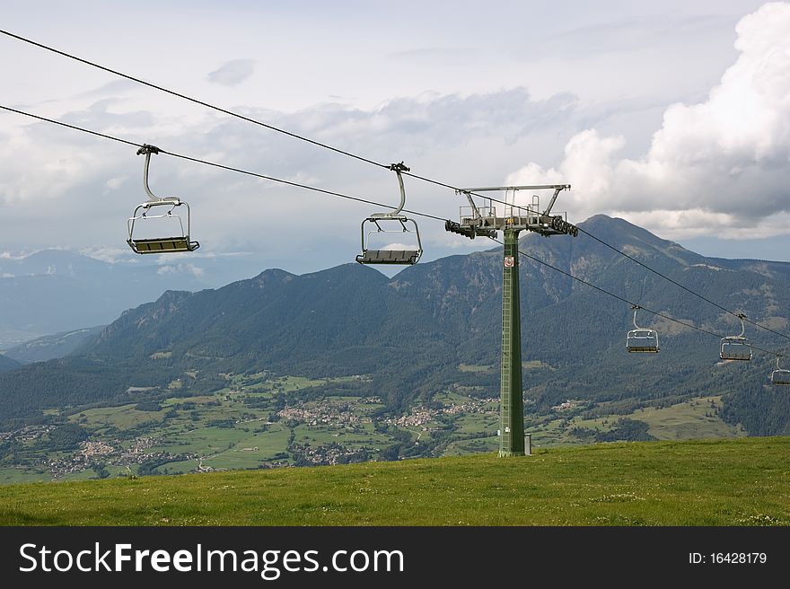 Chair-lift in Italian Alps on a cloudy summer day. Chair-lift in Italian Alps on a cloudy summer day