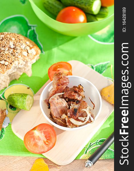 Grilled Meat With Vegetables And Bread Over