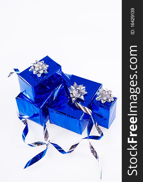 Many blue shiny boxes for gifts with ribbons and tapes