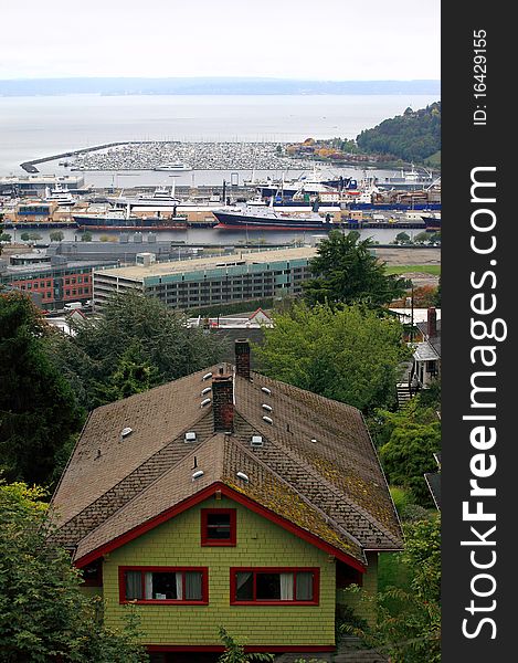 A house on a hillside with the distant marina and fishing vessels in Seattle harbor. A house on a hillside with the distant marina and fishing vessels in Seattle harbor.
