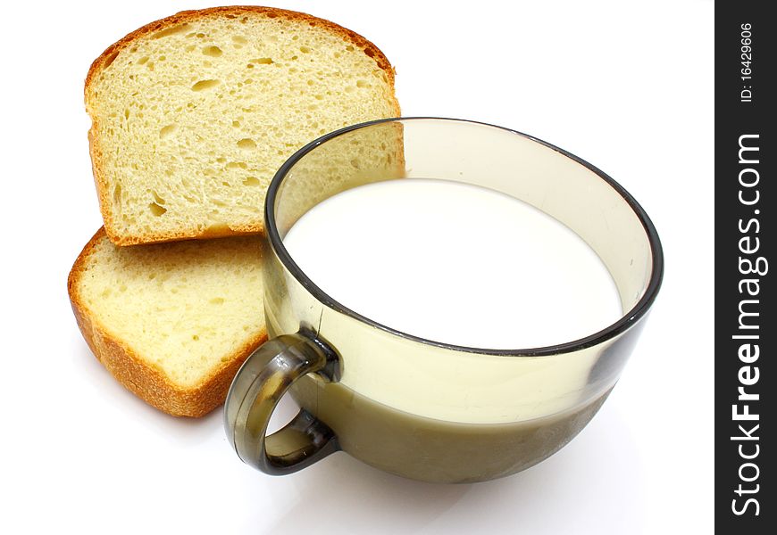 Black bread with milk in a mug on the white isolated background