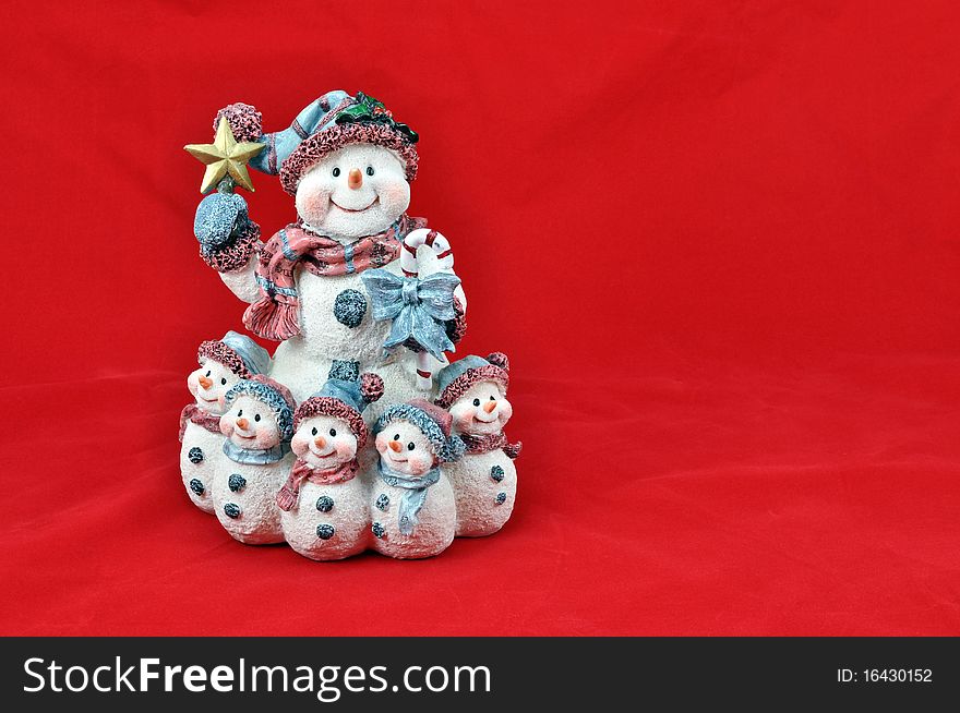 Snowpeople with star on red background