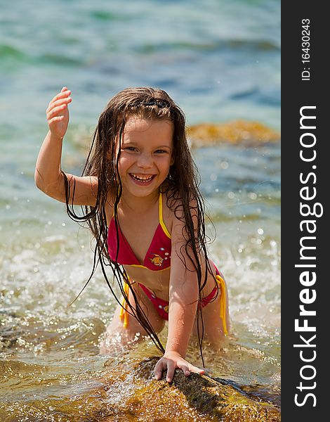 Joyful girl in a bathing suit expresses emotions. Joyful girl in a bathing suit expresses emotions.