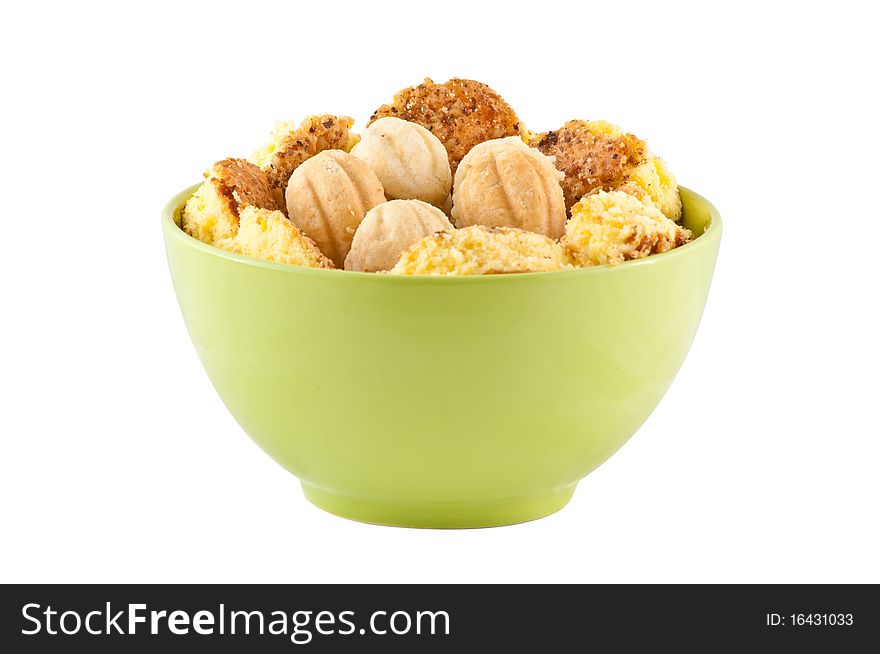 Green bowl with home made cookies on a white background. Green bowl with home made cookies on a white background