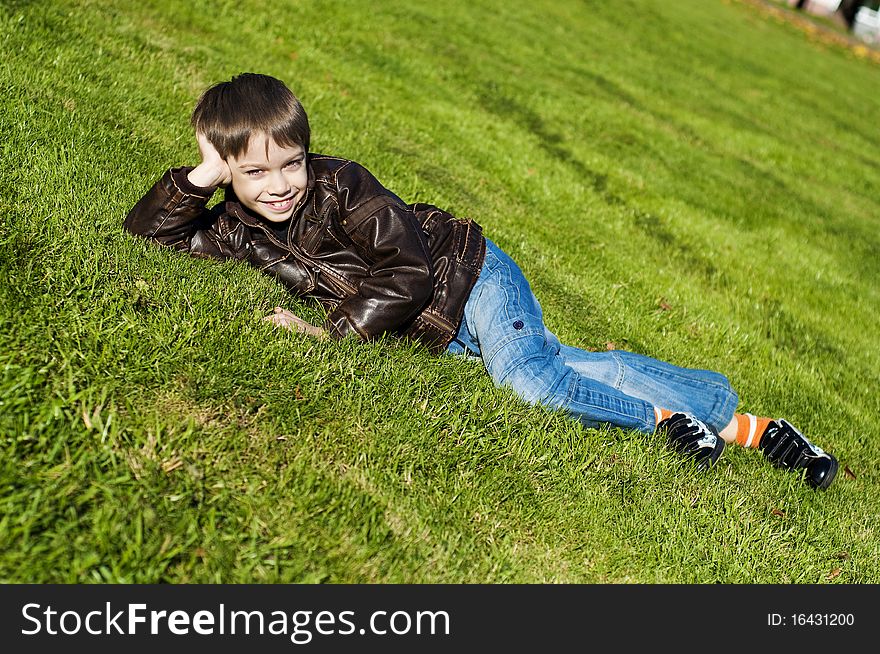 Little boy Lying Down on the  grass