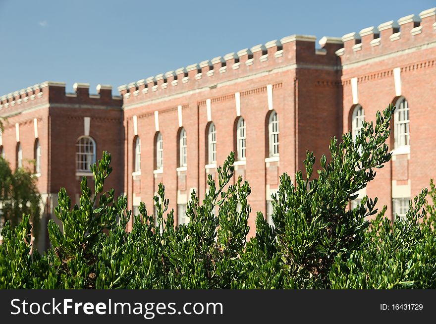 Green bushes in front of red brick fort Victoria on sunny day. Green bushes in front of red brick fort Victoria on sunny day