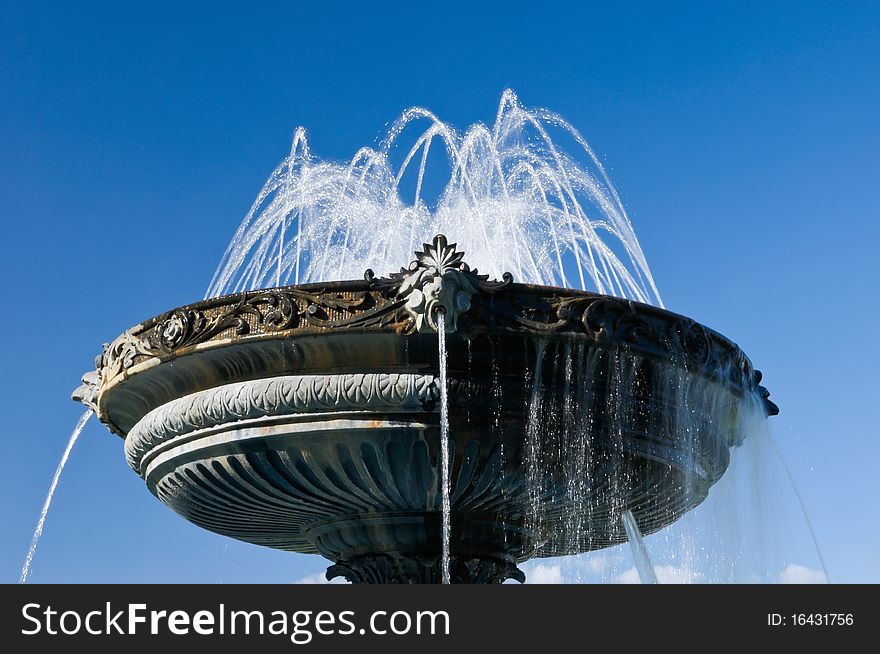 Fountain With Historical Design On Blue Sky