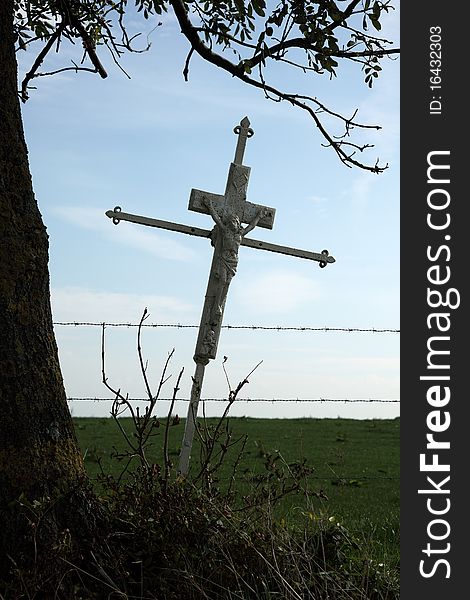 Wrought iron antique cross between the farmlands. Wrought iron antique cross between the farmlands.