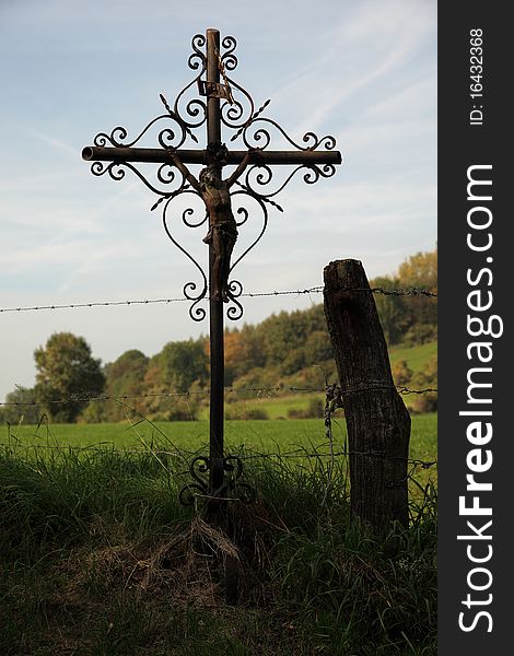 Wrought iron antique cross between the farmlands. Wrought iron antique cross between the farmlands.