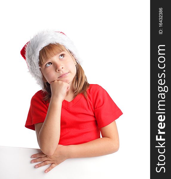 Little girl in christmas hat thinking