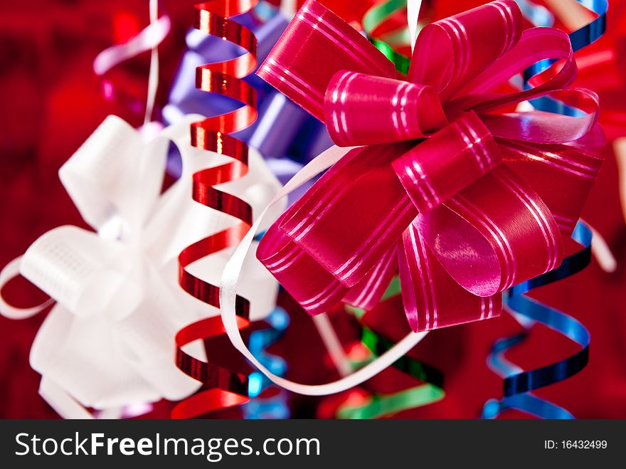 Beautiful christmas bows and ribbons on red background