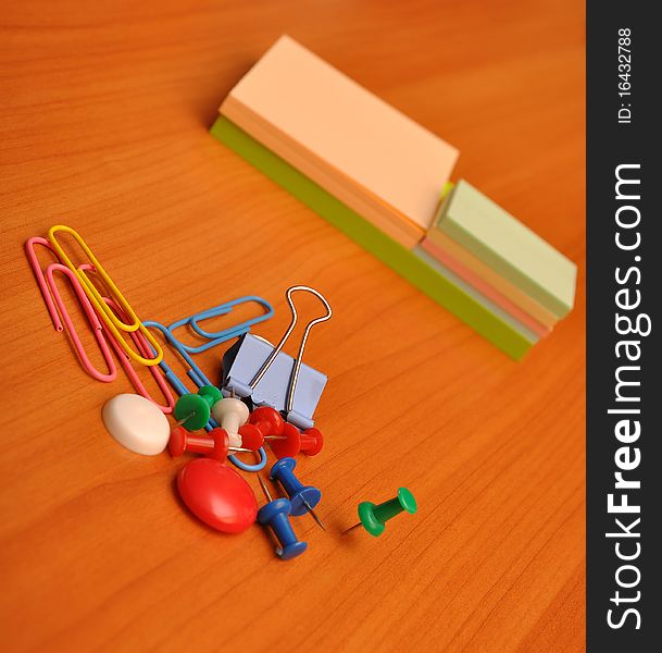 Pile colored note papers and office accessories. Pile colored note papers and office accessories