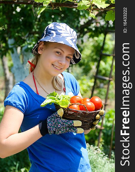 Young woman holding basket with vegetable. Young woman holding basket with vegetable