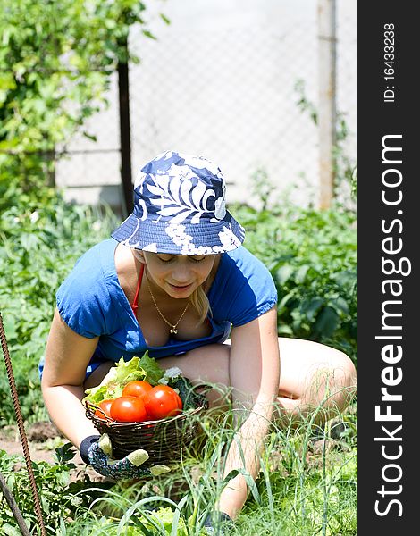 Young beautiful woman working in the garden