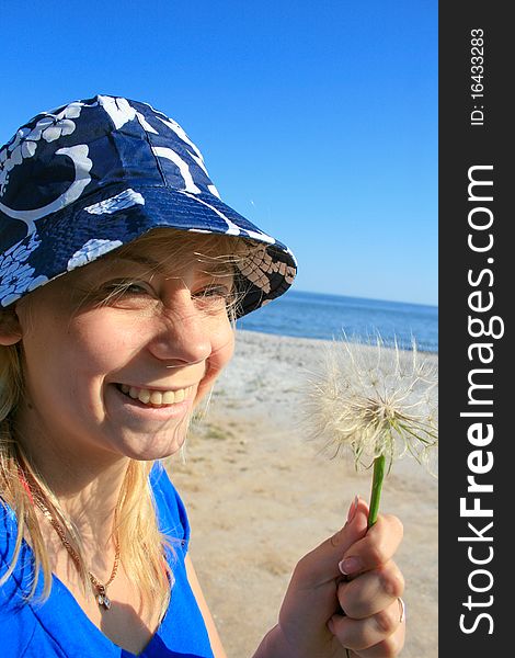 Woman blowing dandelion seeds