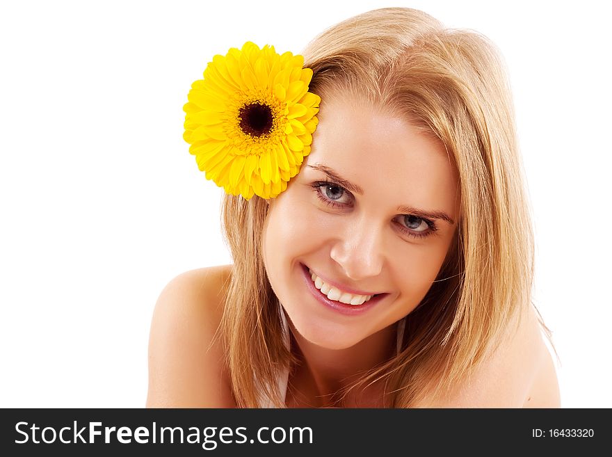 Attractive smiling woman portrait with flower on head, on white background