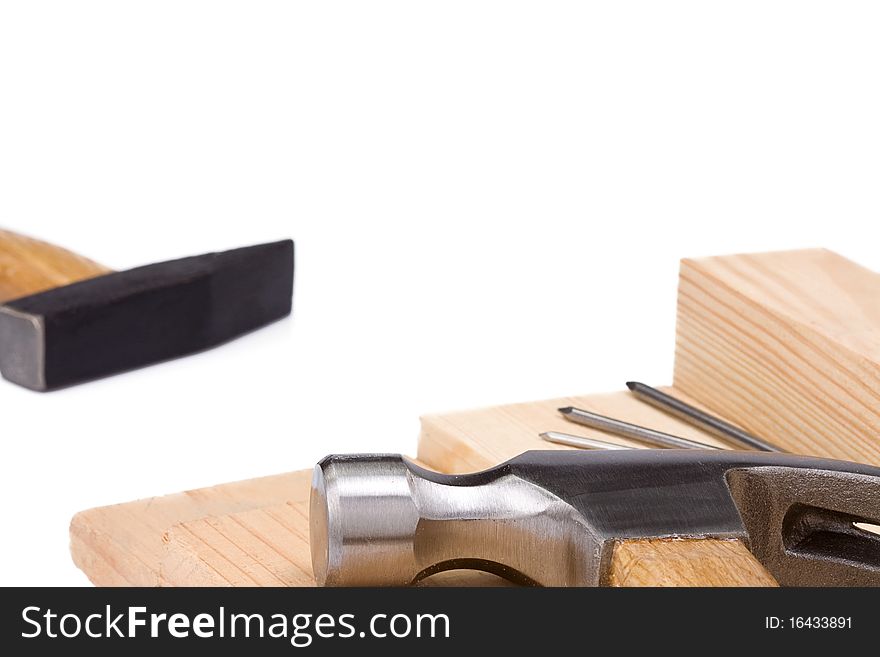 Hammers and nail on wood brick
