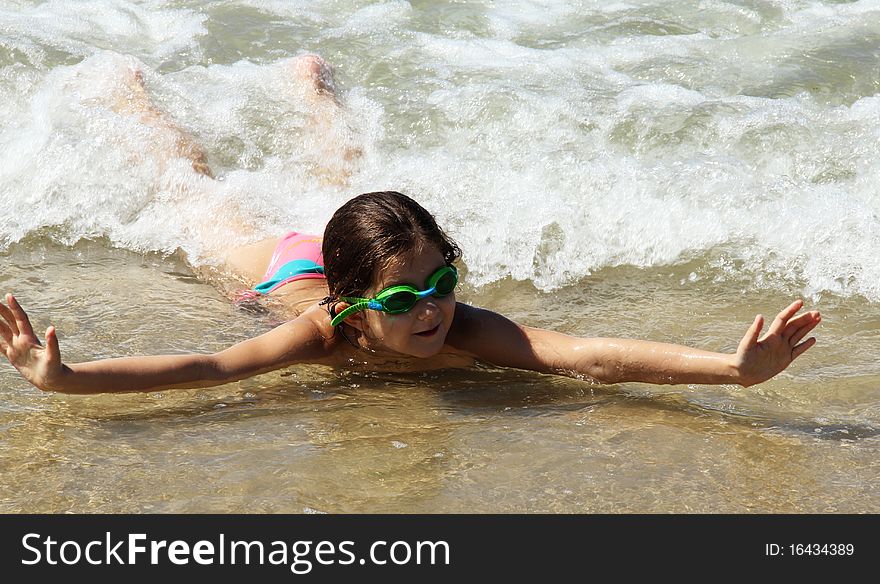 Beautiful, funny, girl seven years at sea. There is no front teeth. She is wearing glasses for swimming. Beautiful, funny, girl seven years at sea. There is no front teeth. She is wearing glasses for swimming