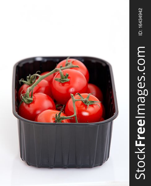 Fresh cherry tomato in box on white background