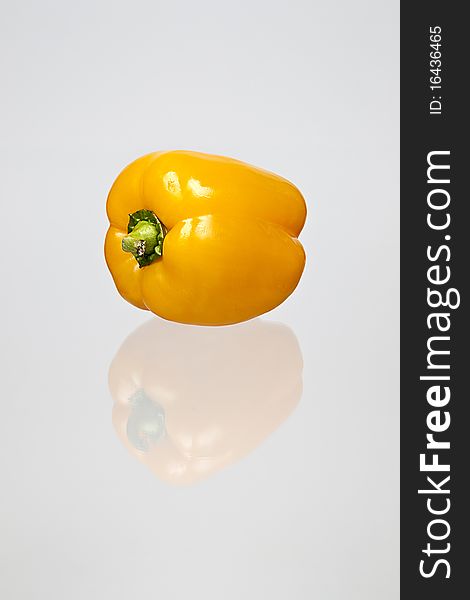 A reflection of a yellow bell pepper