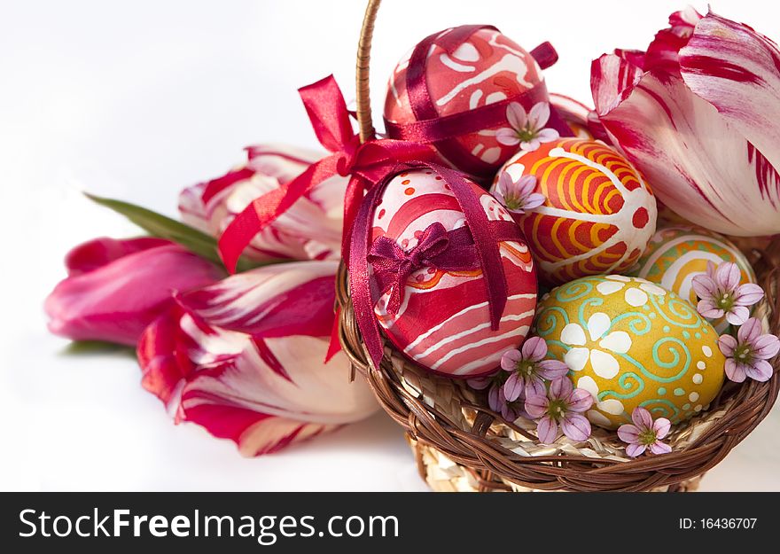 Basket full of Easter eggs and tilips