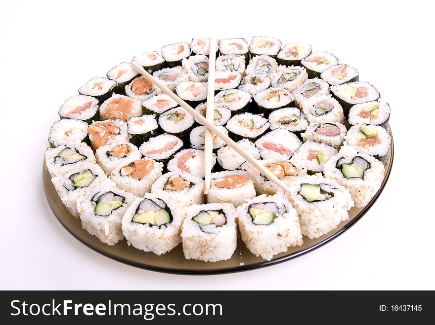 Collection of different rolls served on the round plate. Collection of different rolls served on the round plate