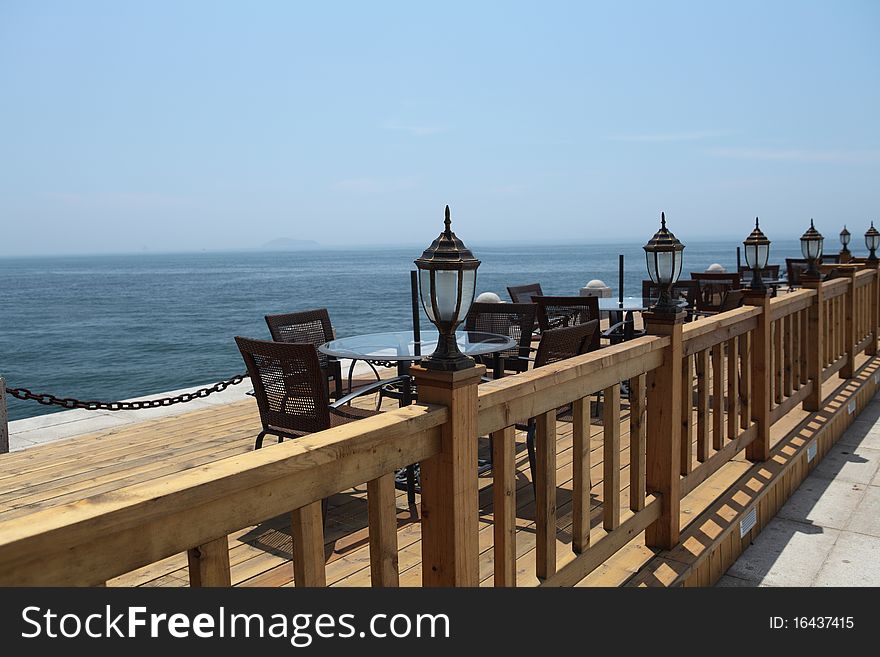 A row of leisure chairs and table at beach