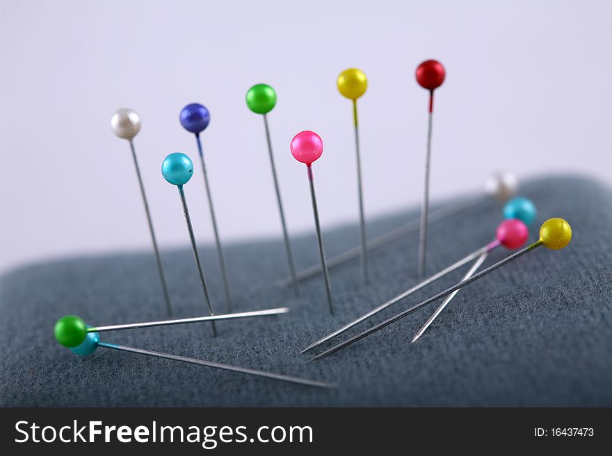 Needle with colorful head with a white background