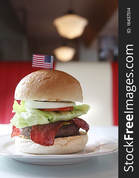 Cheese bacon beef burger with lettuce on the dish. Cheese bacon beef burger with lettuce on the dish.