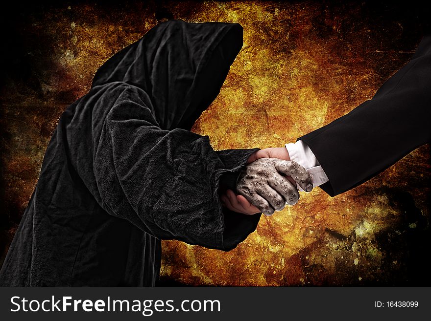Business handshake with reaper, fire background