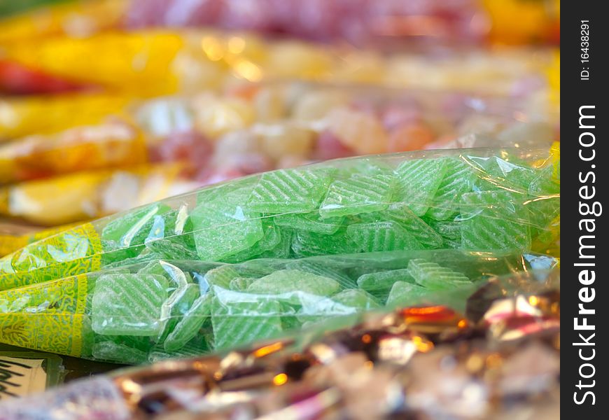 Market stand of colorful candies in the package