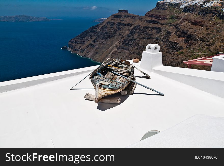 An old boat lying on a roof above the sea. An old boat lying on a roof above the sea.