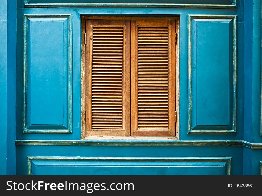 Vintage wooden window on blue wall