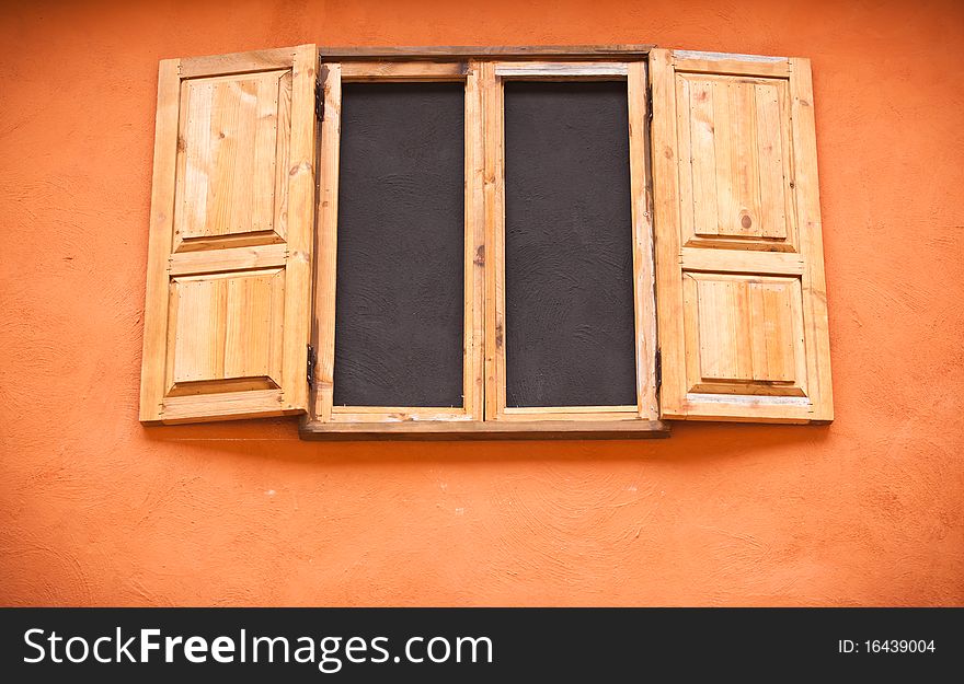 Vintage wooden window on orange wall. Vintage wooden window on orange wall