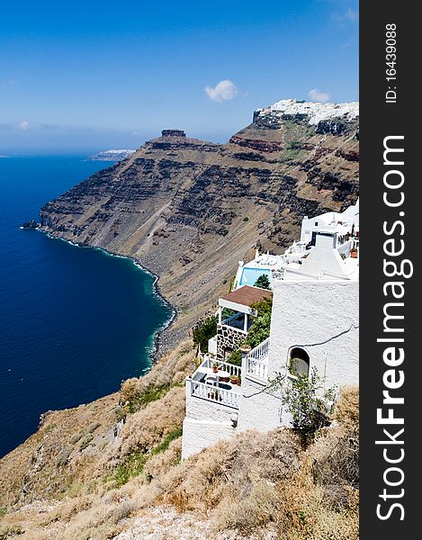 View on the sea and the typical houses in the steep coast on top of the caldera in Santorini, Greece. View on the sea and the typical houses in the steep coast on top of the caldera in Santorini, Greece.