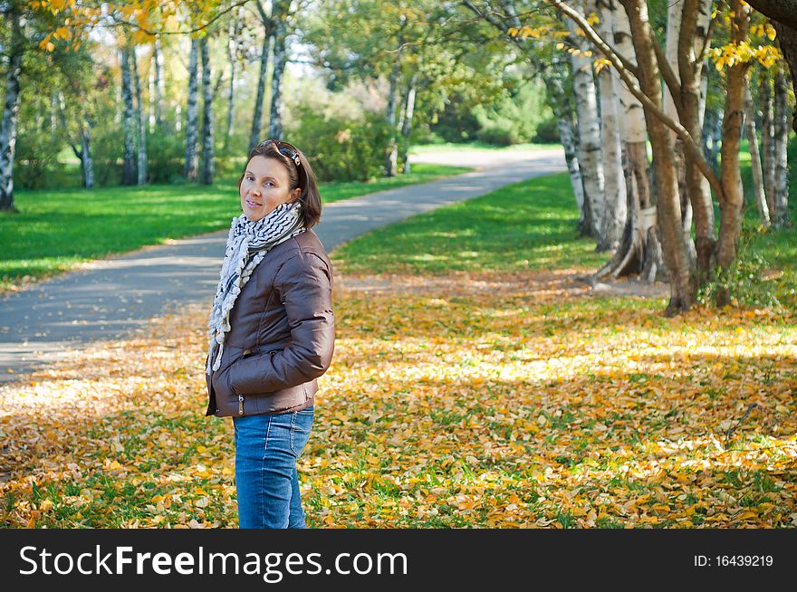 Portrait of a young beautiful woman on autumn walk