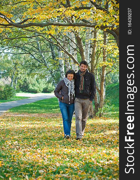 Romantic young beautiful couple on autumn walk