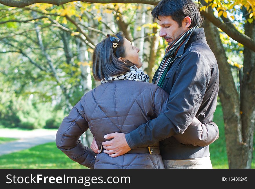 Romantic young beautiful couple on autumn walk