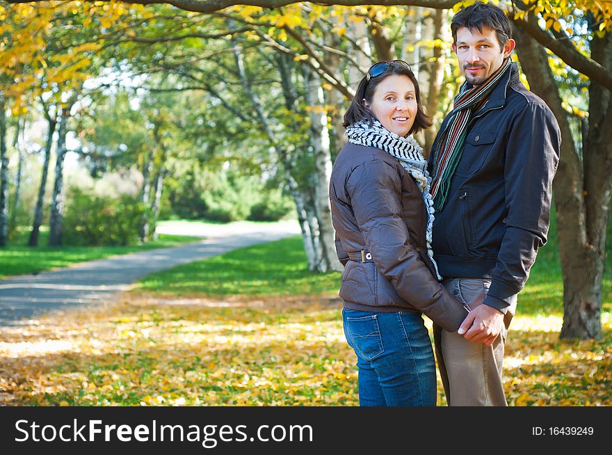 Romantic young beautiful couple on autumn walk